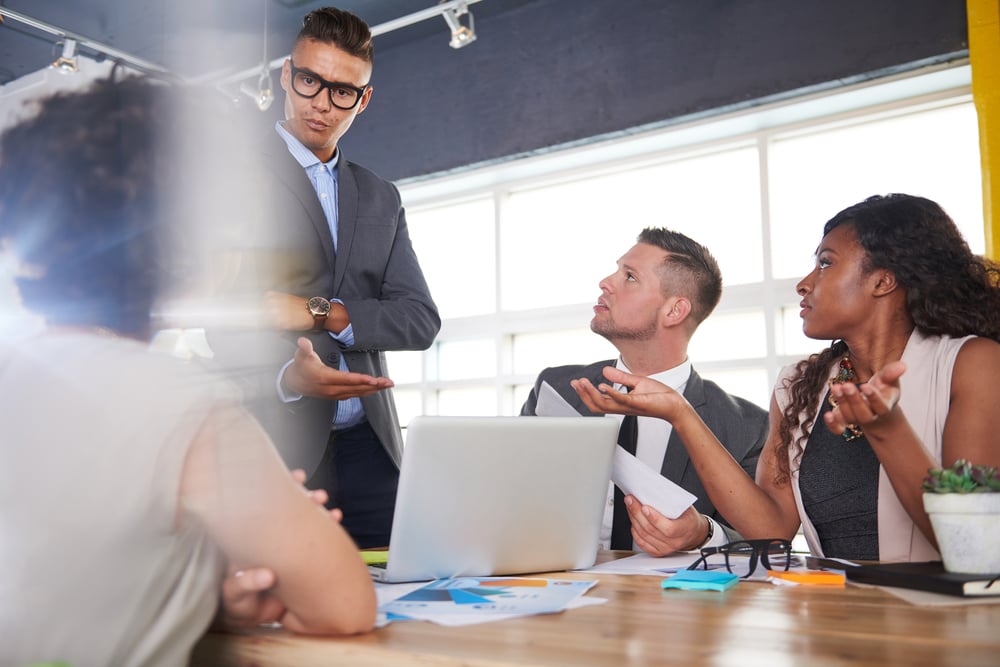team of successful business people having a meeting in executive sunlit office